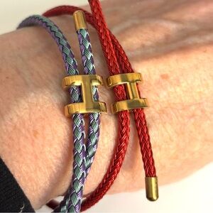 UNISEX H RED OR BLUE-PURPLE CORD
BRACELET FITS ALL SIZES.